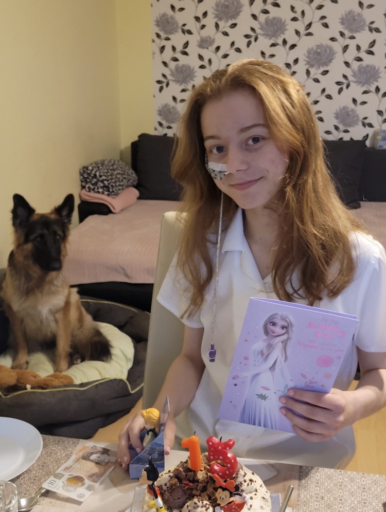 Inspirational Hitchin teenager Emilka Styczynska on her 15th birthday with her dog Luna. CREDIT: The Styczynska family