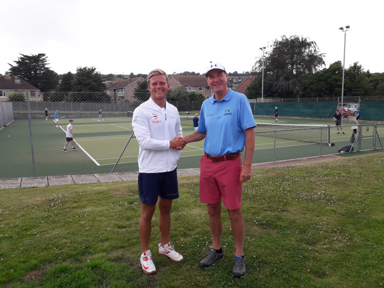 Seaton Tennis Club's new head coach Toby Willis is welcomed by chairman Simon Prior