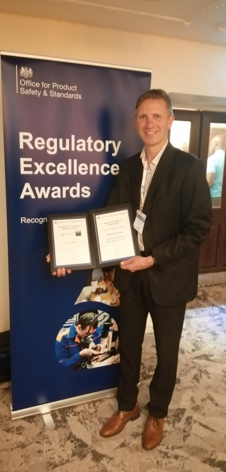 Michael Berry, MDC Environmental Health Officer accepting two awards for the wasted food project at the Regulatory Excellence Awards 2022.