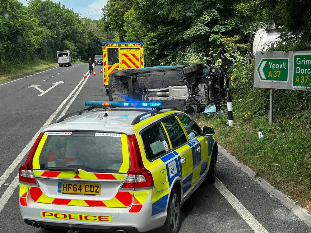 Long Ash Lane was closed this morning after a two-car crash left one on its side (Image: Dorchester Fire Station)