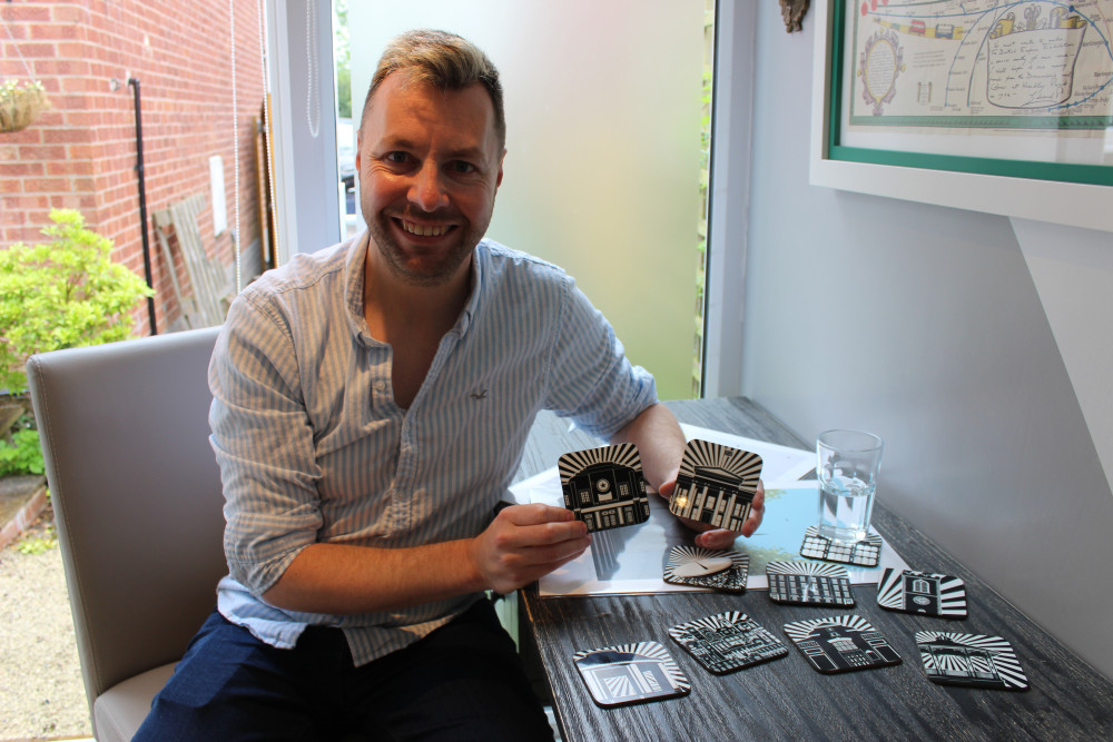 Adam with his new top-selling Macclesfield coasters. He is pictured holding ones of The Picturedrome (of Chestergate) and Macclesfield Town Hall (of Market Place). They cost a fiver each, or can be cheaper when bought in groups. (Image - Alexander Greensmith / Macclesfield Nub News) 