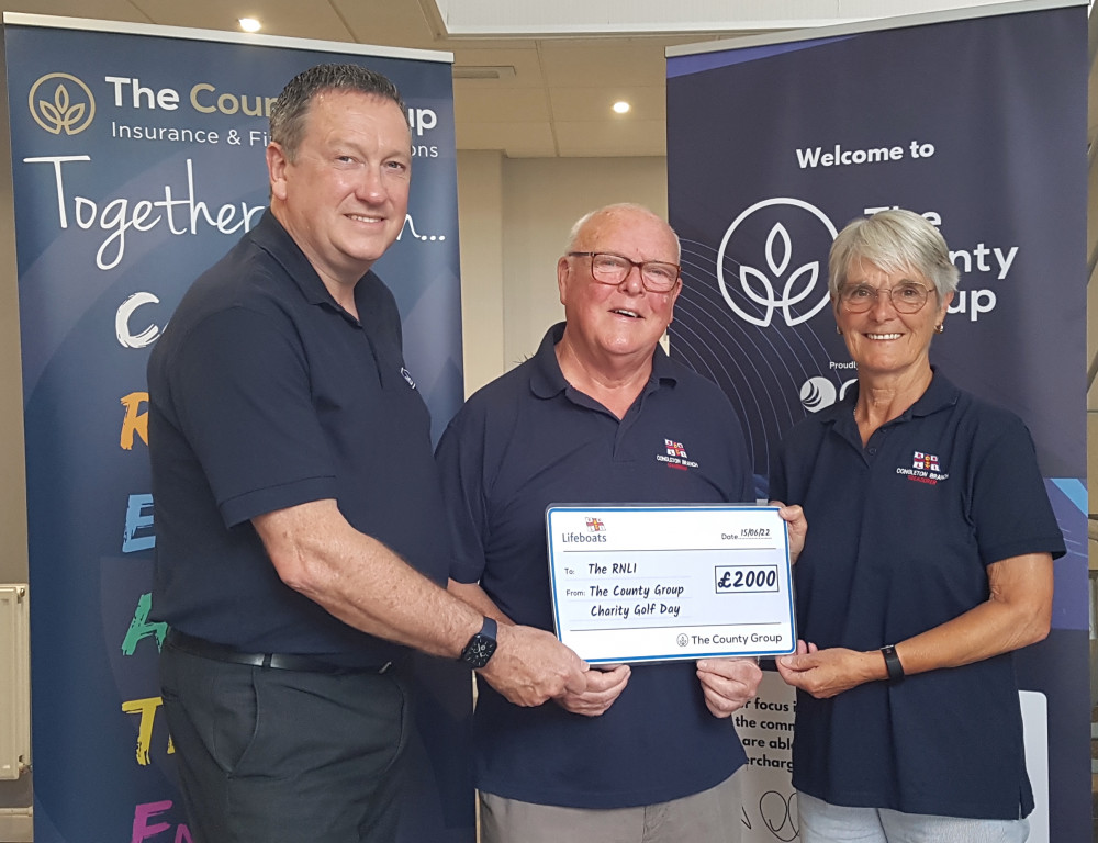 The helpful handover: Congleton RNLI chairman John Lawson and his wife, Sandra, the branch treasurer, receive a £2000 cheque from The County Group CEO Alastair Christopherson. 