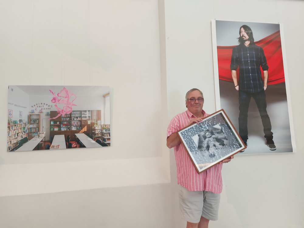 Frome photographer David Chedgy holds one of the incredible NASA photos at the show in Rook Lane