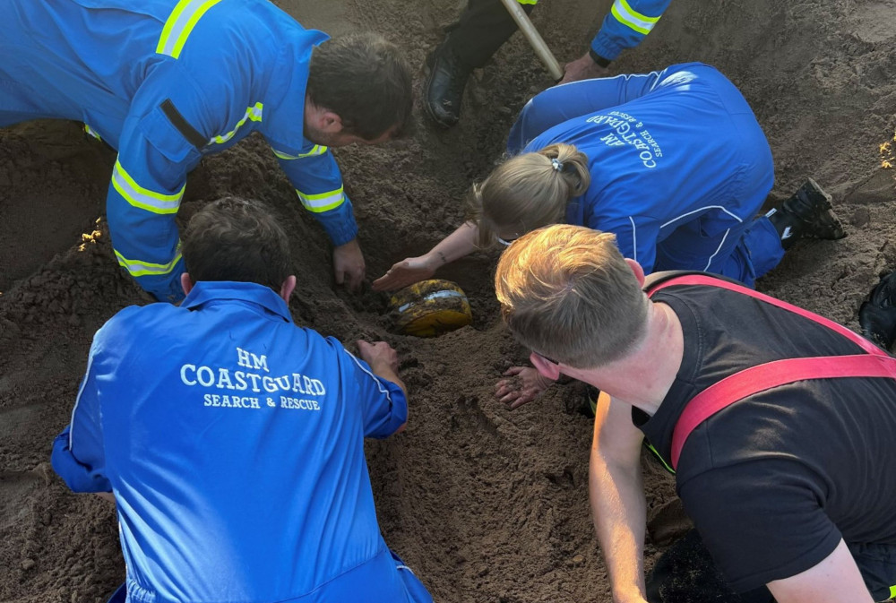 It took 40 people around half an hour to get to the 'casualty' buried under a couple of feet of sand (HM Coastguard)