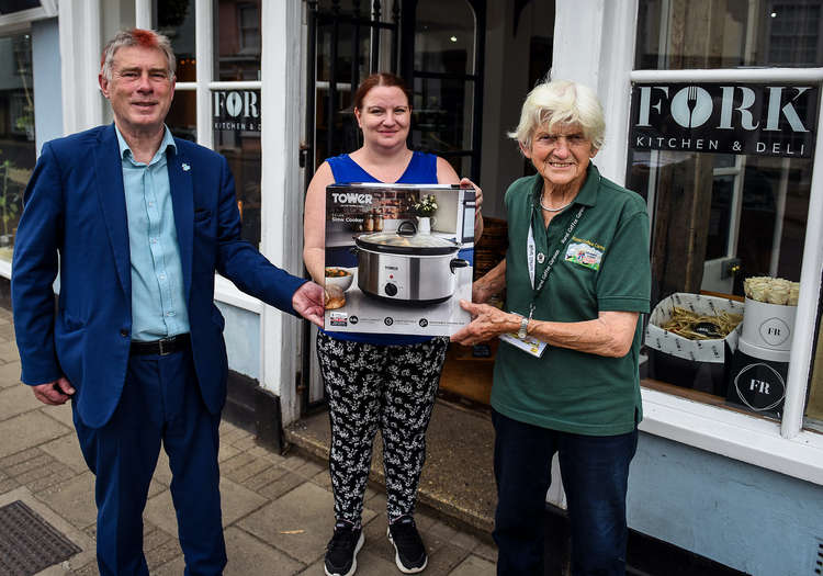 Cllr Derek Davis, Babergh's cabinet member for Communities presents a slow-cooker to an attendee of the Hadleigh cookery project at the Fork, along with a representative from the Rural Coffee Caravan (Photo credit: Gregg Brown and Babergh)