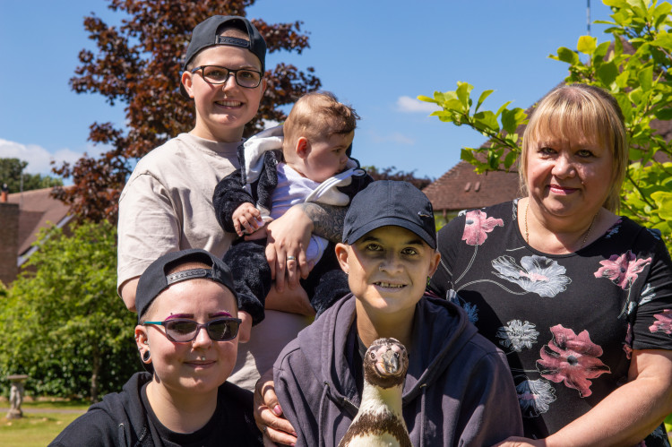 Jenny with her mum, friends and one of the penguins (image supplied)