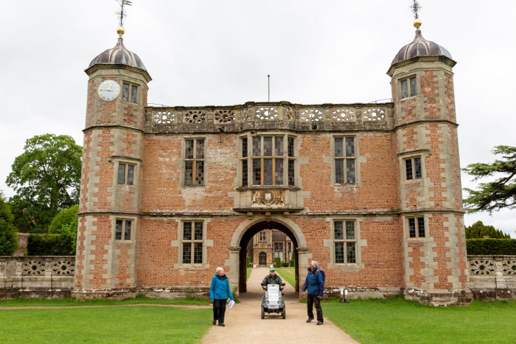 Members of the Disabled Ramblers exploring the buildings around Charlecote Park on foot and using a mobility vehicle. (Photo ©National Trust Images - Annapurna Mellor)