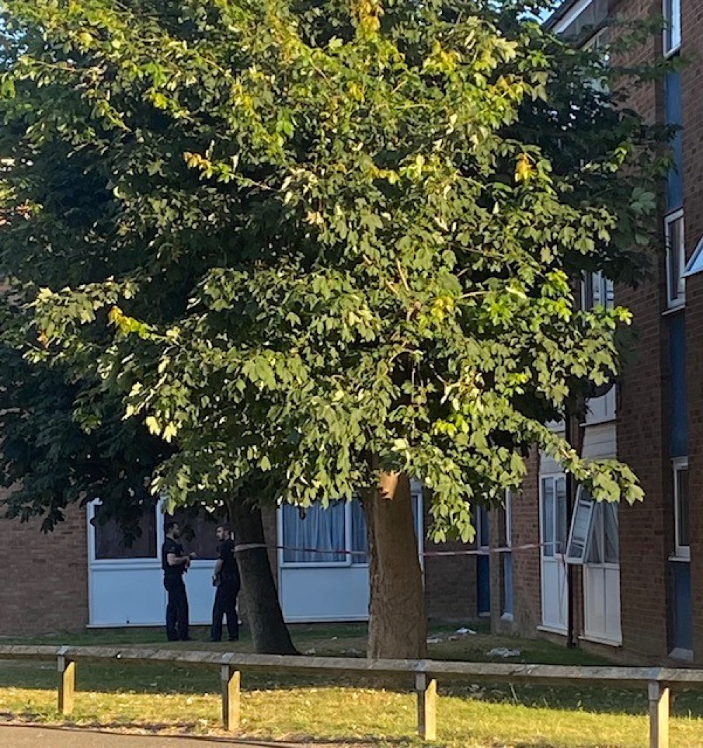 Police cordoned off an area outside the flats where the child fell.