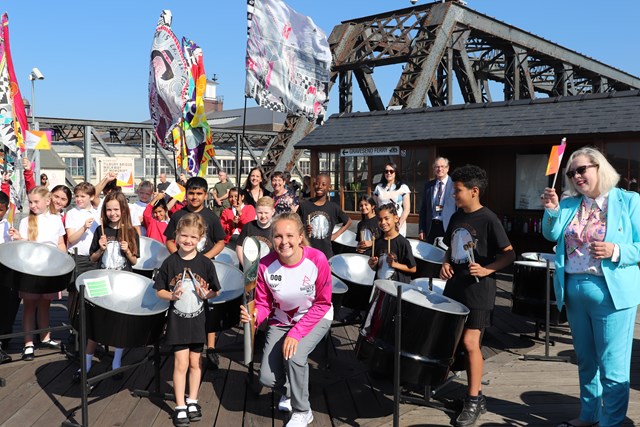 Batonbearer Emily Defroand with schoolchildren including the Woodside band and MP Jackie Doyle-Price.