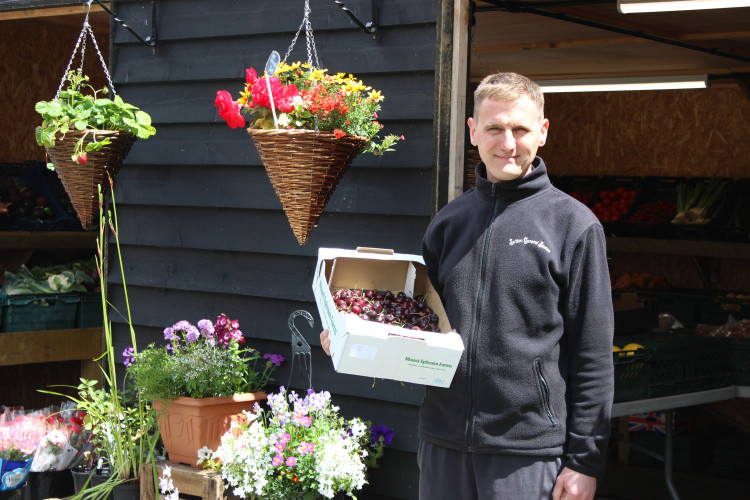 Alan Bolshaw of Sutton General Stores, holds some of the British-grown produce from his under-threat fruit and vegetable shed. (Image - Alexander Greensmith / Macclesfield Nub News)