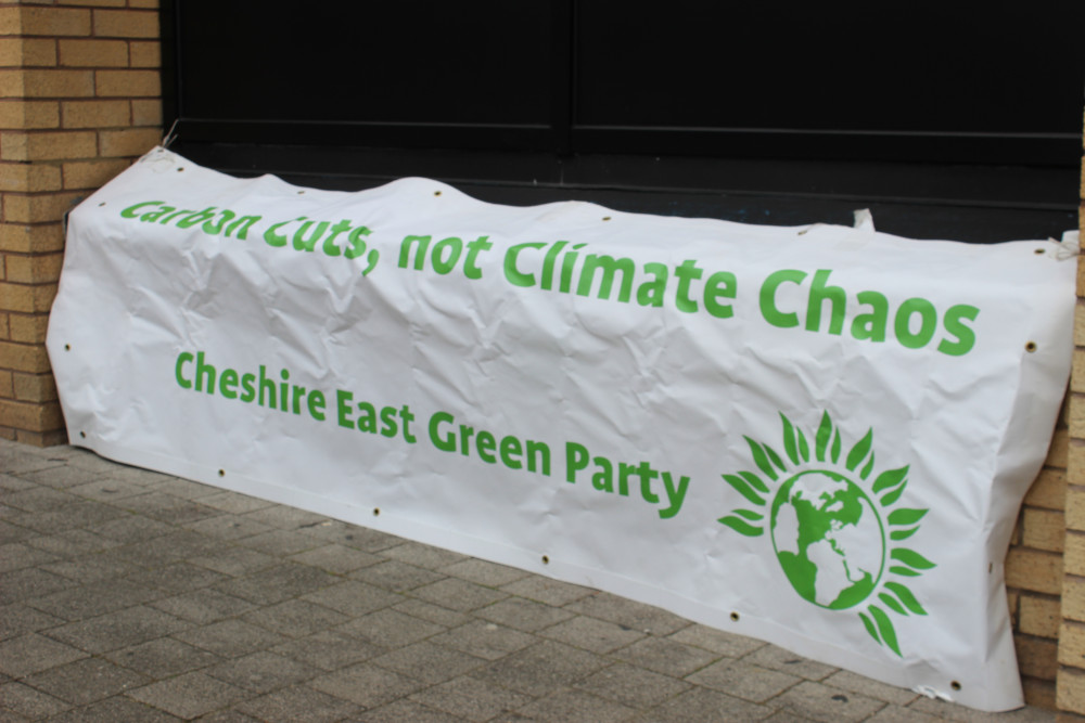 A Cheshire East Green Party banner, held at the entrance of a Cheshire East Council meeting, during May's 'SAVE DANES MOSS' protest. (Image - Alexander Greensmith / Congleton Nub News) 