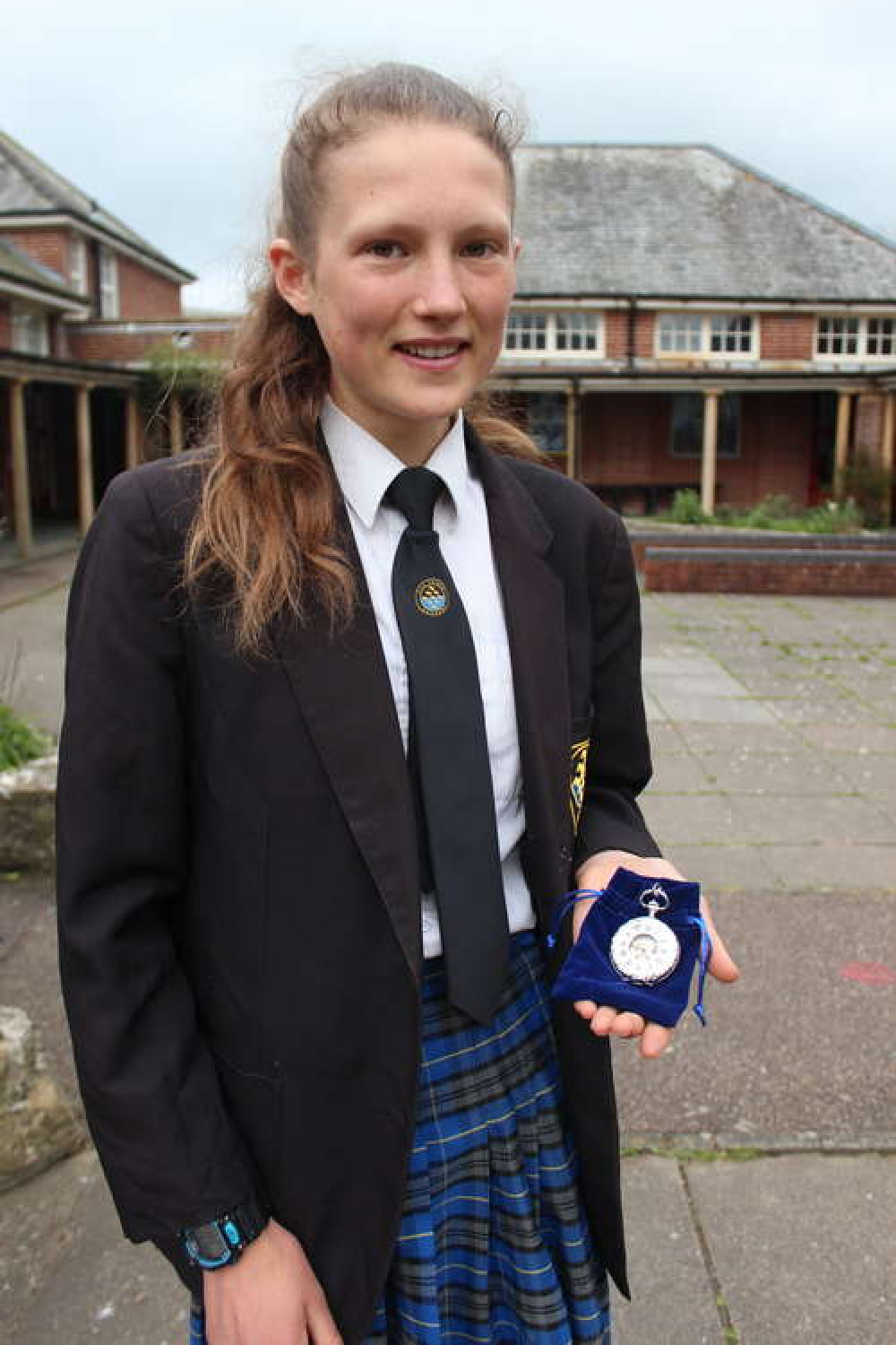 Innes Fitzgerald pictured with the pocket watch presented to her by Axe Valley Academy staff