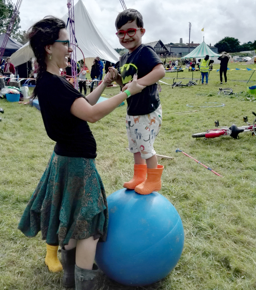 A boy tries out the Circus Workshop at Family Festival 2021