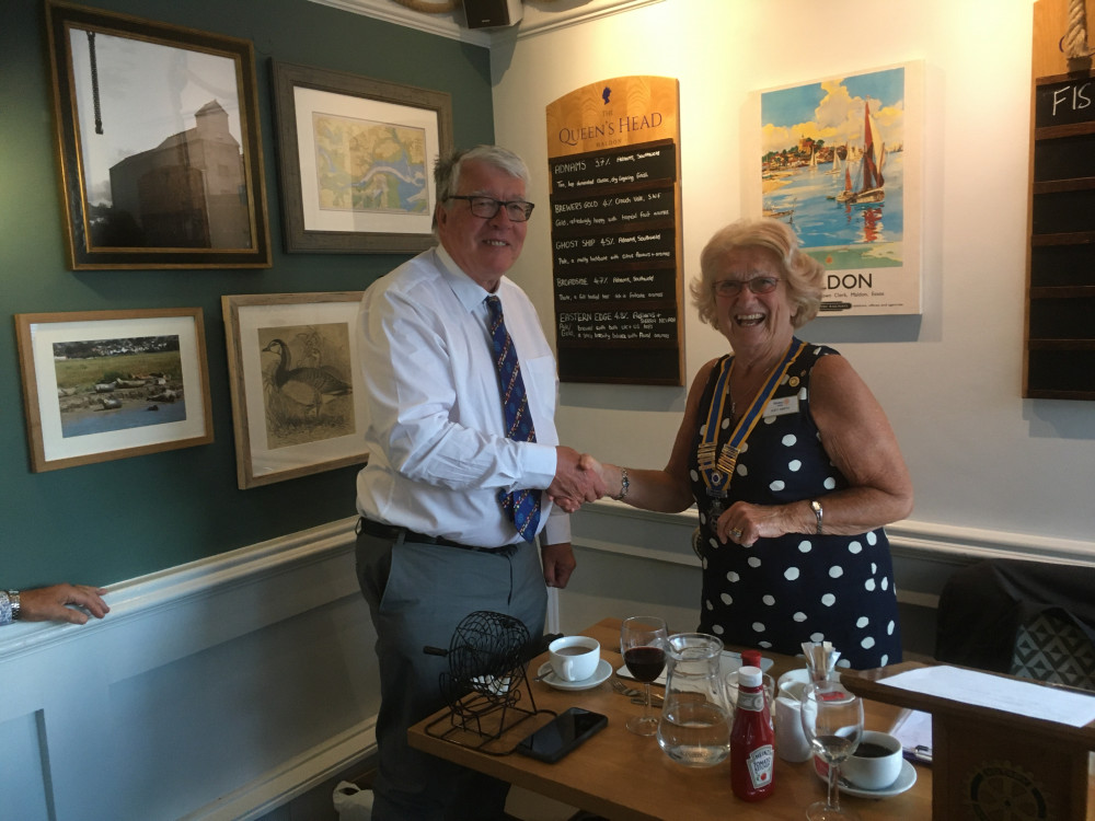 John Williams hands over the chain of office to Judy Smith, who will be President of the Club for its 60th year.