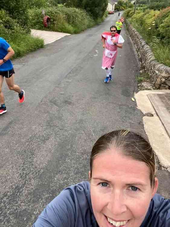 Becky Stringer, Andy Eptlett (who was challenged to wear a dress) and others climb the Killer Mile