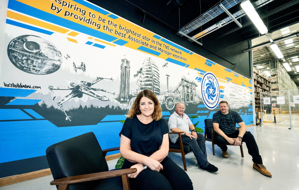 Tracey Foster, Cllr Keith Merrie MBE and artist Si Bennett in front of the new Amazon mural