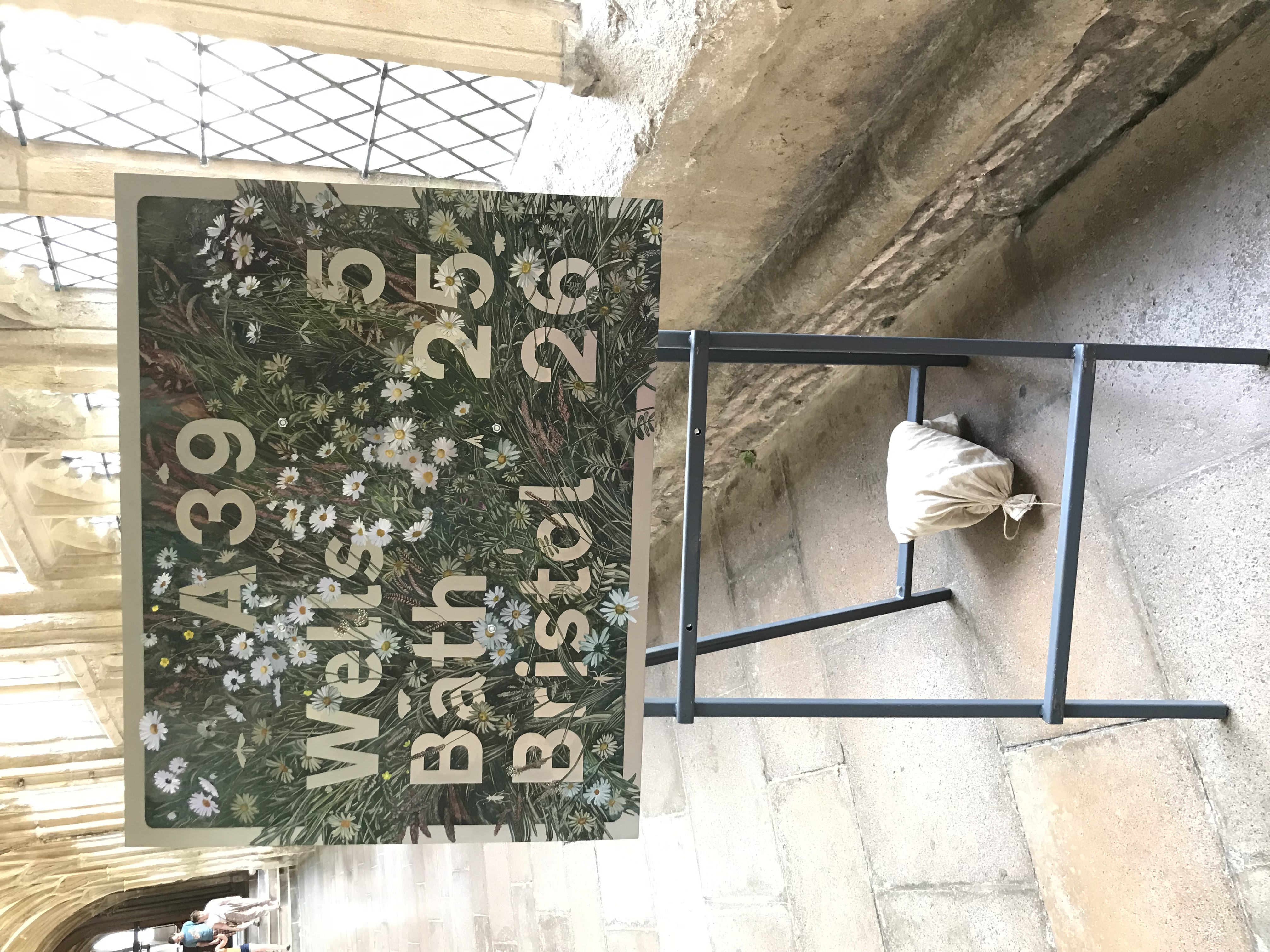 Wells Five Miles by Nessie Ramm. Signs from locations around Wells have been recreated in the Cathedral, adorned with local flowers and plants