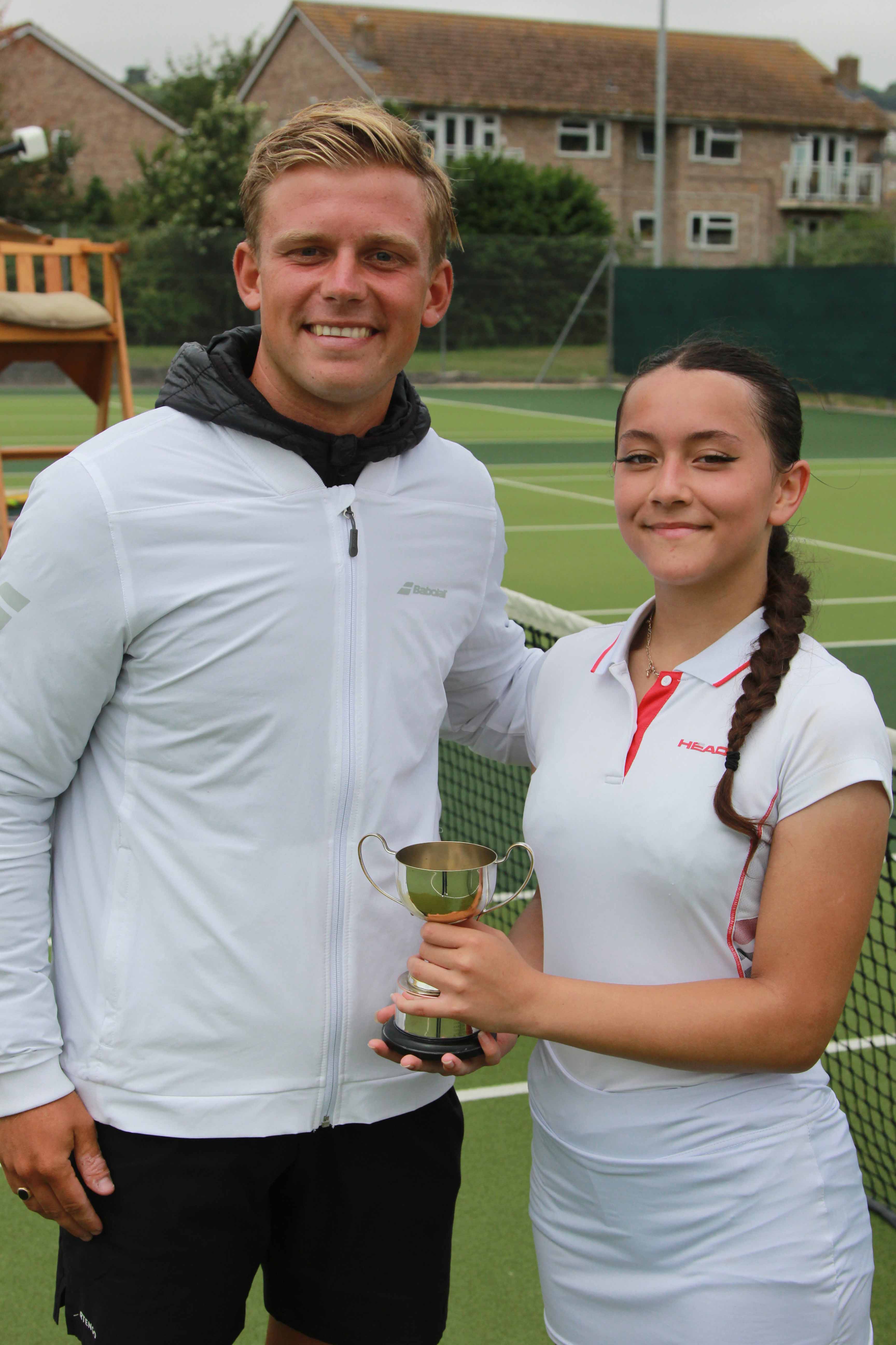 Head coach Toby Willis presents the ladies singles trophy to Zanna Newsholme