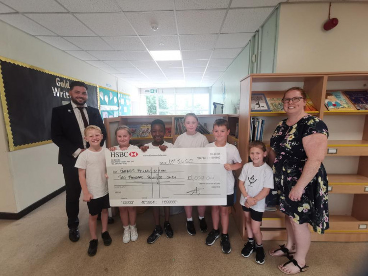 Griffin's Stanford branch partner Curtis Johnson (left) with pupils and teacher Mrs Roberts.