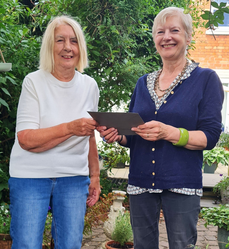 Brenda Bannister (left) presents Nikki Copleston with her prize cheque