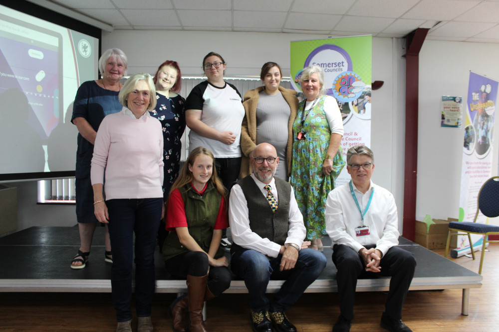 Cllr Tessa Munt, Somerset County Council Lead Executive Member for Children and Families, Holly Churchill SICC & SLCC (Somerset In Care / Somerset Leaving Care Councils) Volunteer, Councillor Leigh Redman, Julian Wooster Director of Children’s Services  Left to right back row:  Jane Lock Chair of the Corporate Parenting Board, Chloe Walker Corporate Parenting Board Volunteer, and Roxanne Leakey & Tish Fiddy SICC and SLIC volunteers, Fiona Phur Service Manager Partnership Business Manager SCT & SCPB CSC Partnership Business Unit