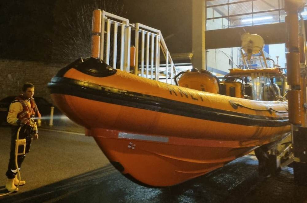 A crew member washing down the lifeboat. (Image credit: RNLI Penarth Lifeboat Station - Facebook)