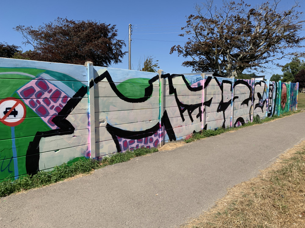 The Bridport mural now defaced with graffiti