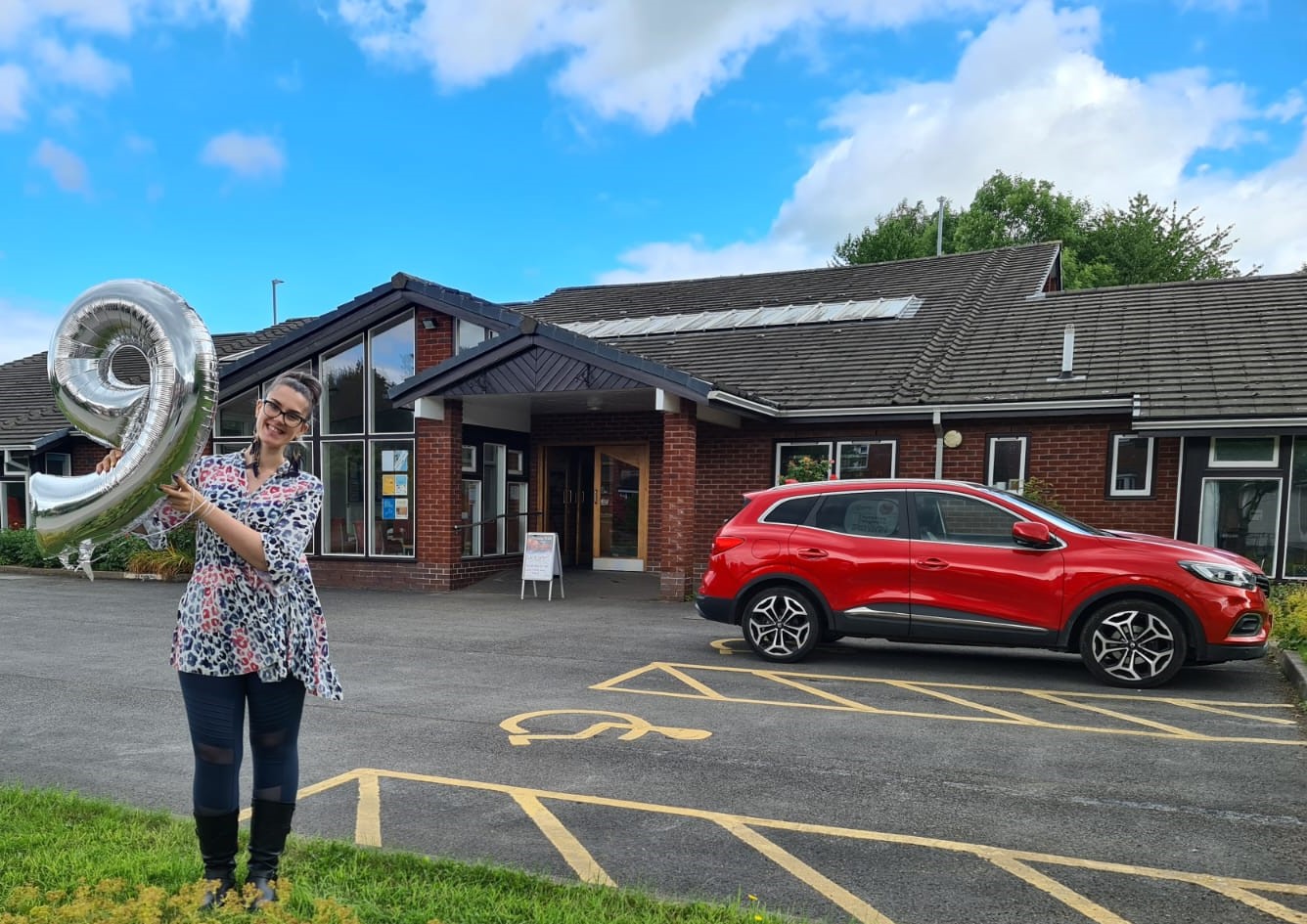 Congleton resident Laura with her nine year anniversary balloon outside the Wellspring Church's main entrance. (Image - Slim with Laura B)