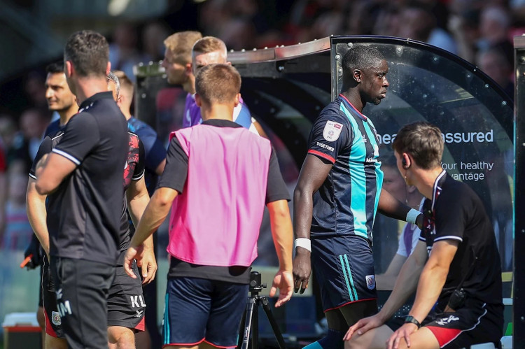 Bassala Sambou was sent off for Crewe in the 31st minute after grabbing the throat of Salford City defender, Theo Vassell (Kevin Warburton).