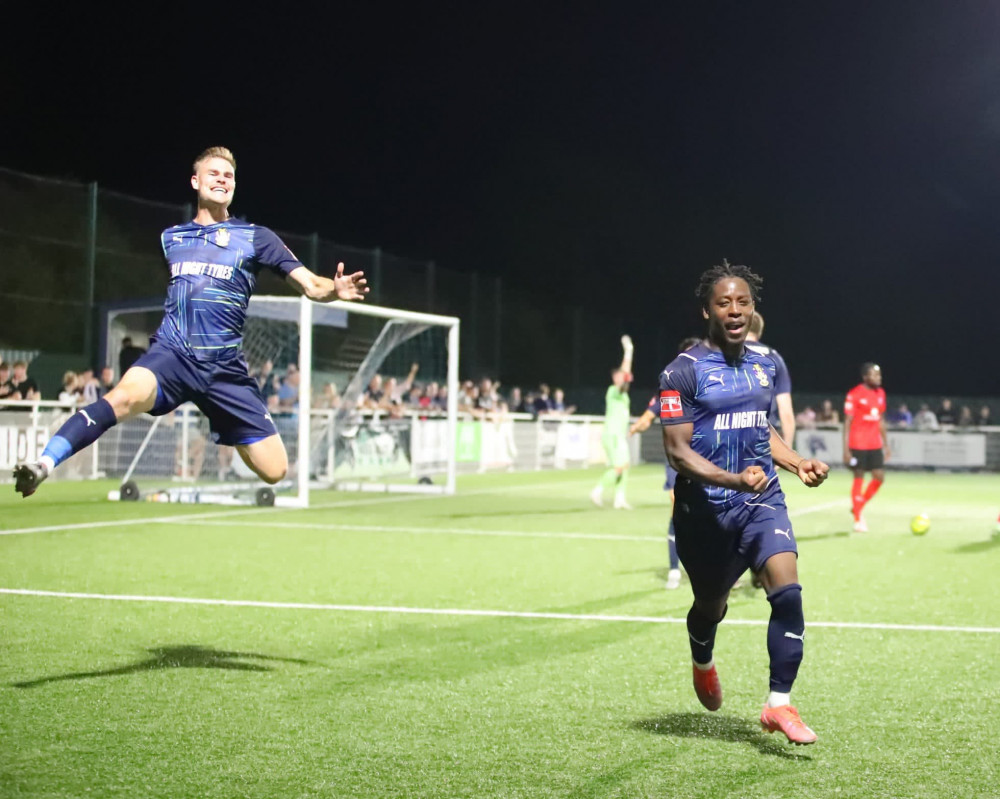 Harry Gibbs leaps for joy as goalscorer Bryan Ifeanyi runs to the crowd to celebrate what proved to be the winning goal. Picture by Kevin Lamb (Lambpix).