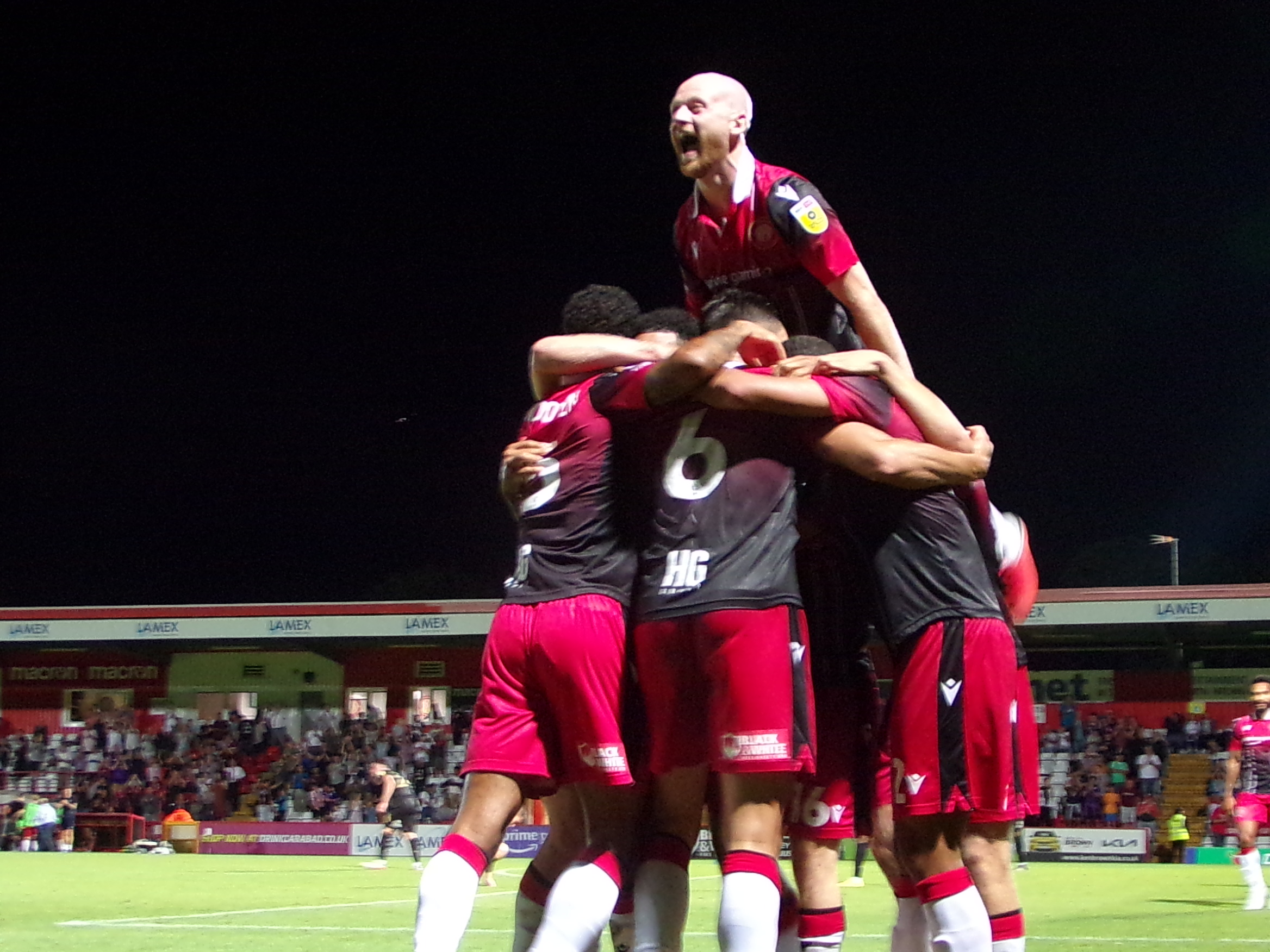 The jubilant Stevenage players celebrate after Jamie Reid's late winner beat Peterborough. CREDIT: George Bigley 