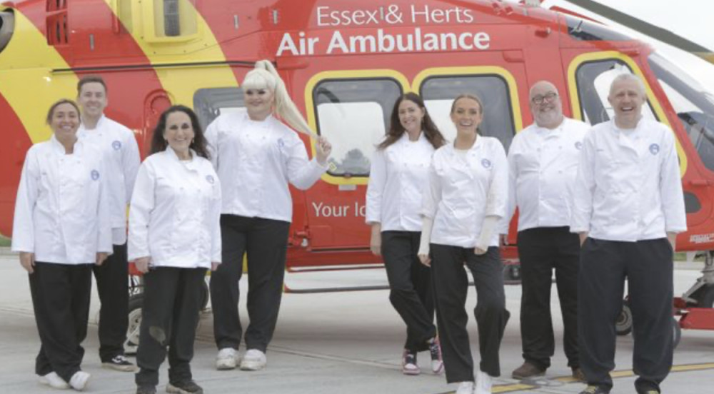 Celebrity MasterChef Semi-Final Week contestants Mel Blatt, Danny Jones, Lesley Joseph, Kitty Scott-Claus, Lisa Snowdon, Faye Winter, Cliff Parisi and Jimmy Bullard in front of the Essex & Herts Air Ambulance. - Credit: BBC/Shine TV