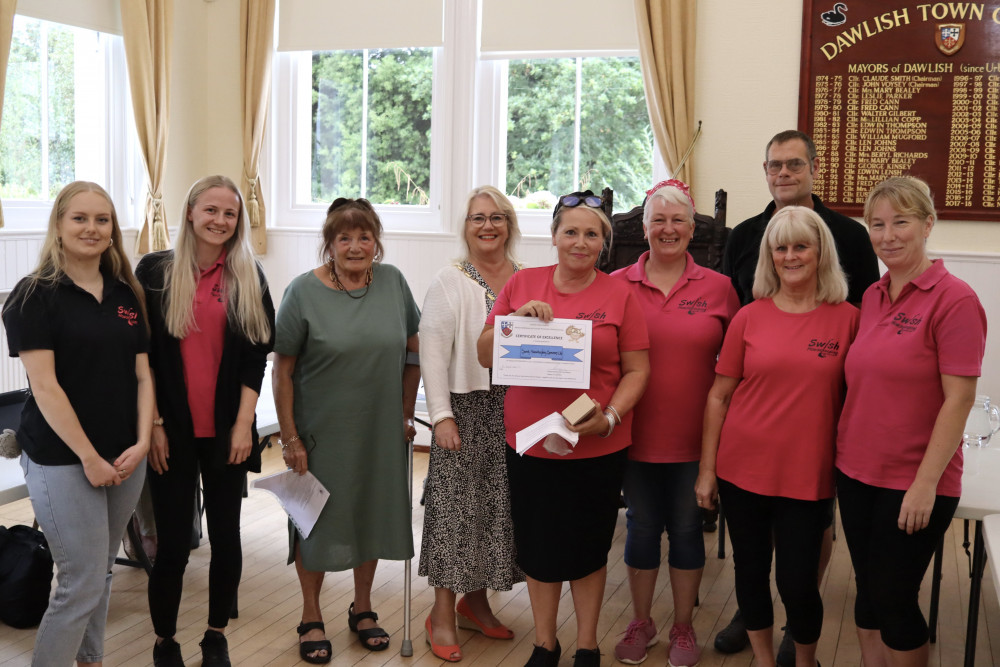 Sarah Plaatsman (centre) with Swish Housekeeping team, Cllr Carole Tamlyn (third from left) and Dawlish Mayor Cllr Lisa Mayne (fourth from left) (Nub News/ Will Goddard)