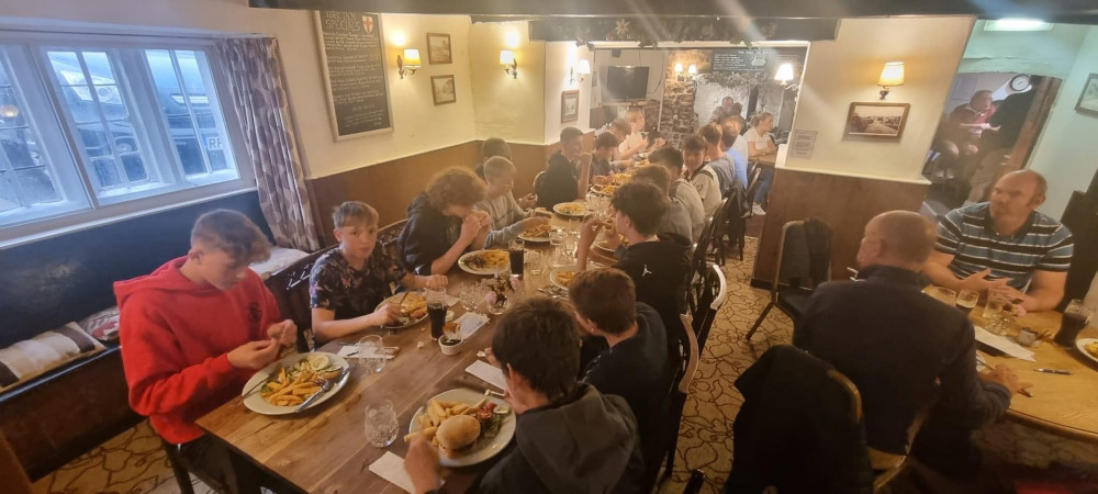 Axminster Two Under 15s tucking into their pre-season celebration at the York Inn