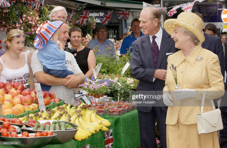 Her Majesty during a visit to Kingston upon Thames in 2002 with Prince Phillip, the Duke of Edinburgh (Credit: getty images). 