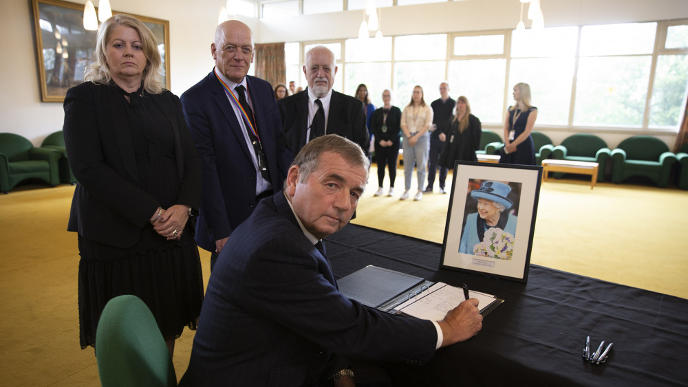 Vice Lord Lieutenant, Col. Murray Colville (front), Leicestershire County Council Chairman Kevin Feltham (right), Leader Nick Rushton (middle), and Deputy Leader Deborah Taylor (left) sign the book of condolence at County Hall