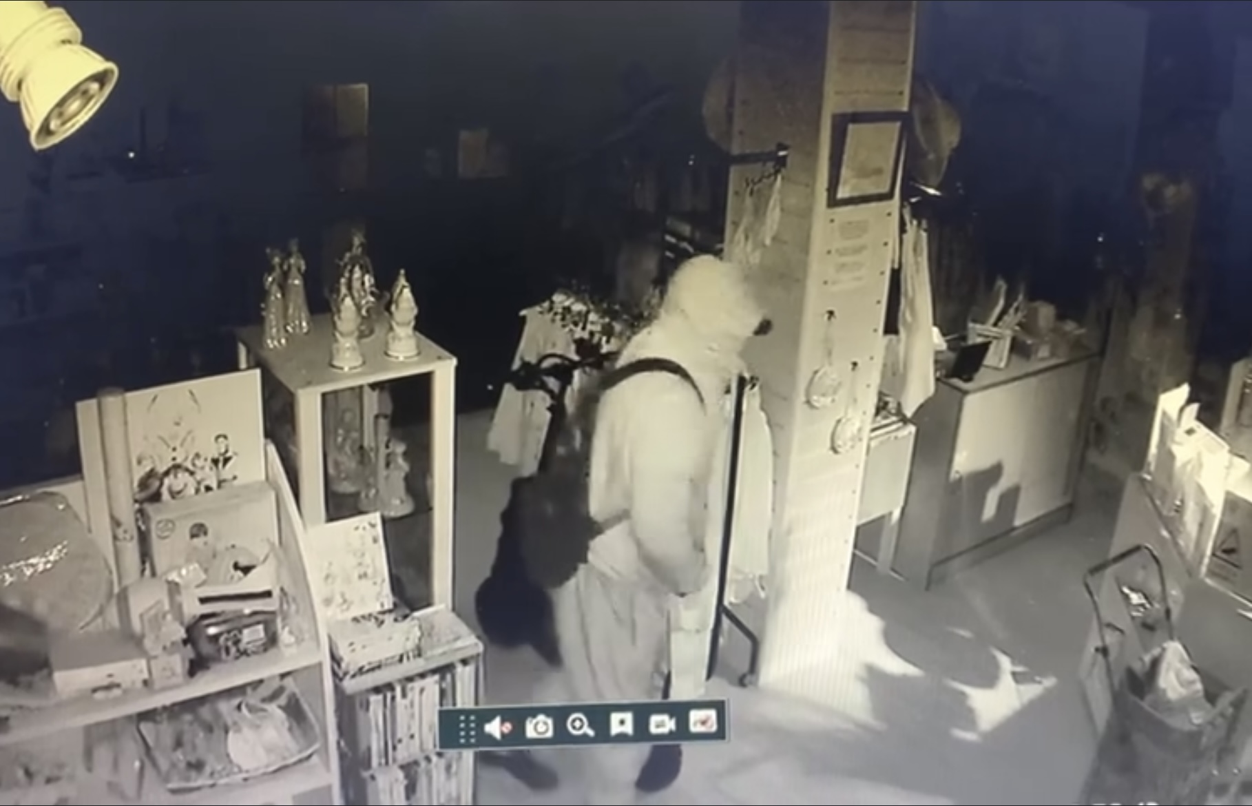 A still from CCTV at the Seaton & District League of Friends charity shop in Fore Street, showing the thief in a hooded jumper
