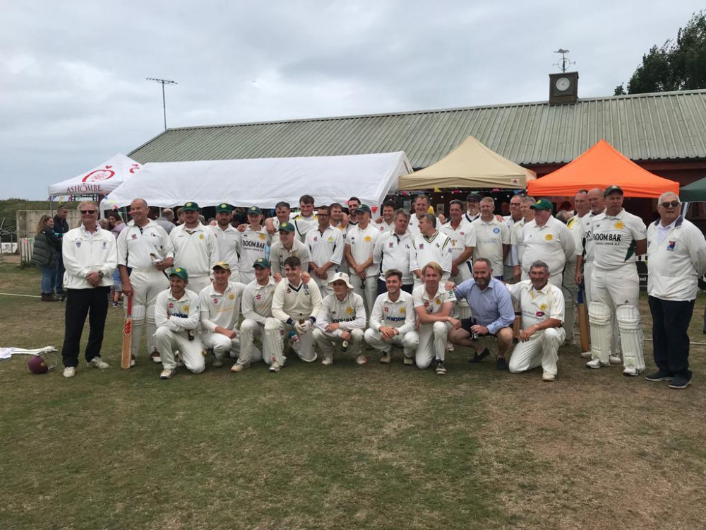 A team photo of all the players past and present with the umpires and 1st team scorer Andy Parker