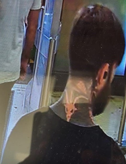 Do you recognise this distinctly tattooed man police would like to talk to?