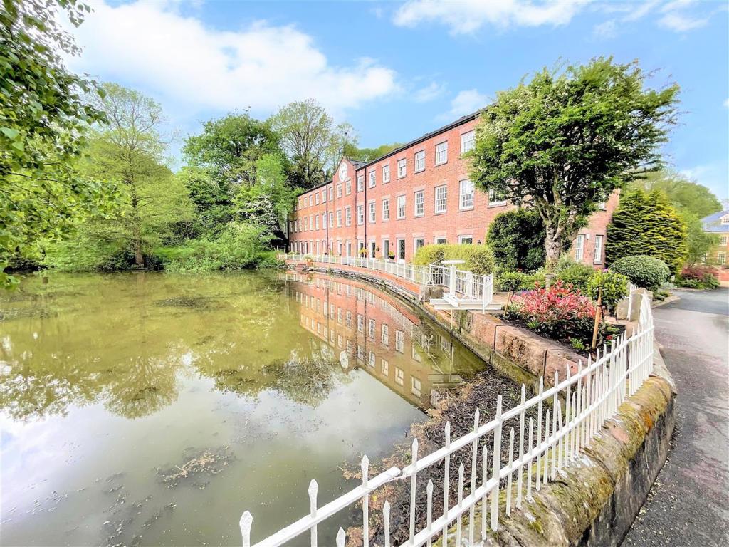 A stunning home by a tranquil mill pond.