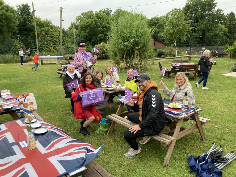 Zuby Majeed, holding the Co-op Jubilee box, with guests at today's picnic at Penarth Lawn Tennis Club. (Image credit: Jack Wynn)