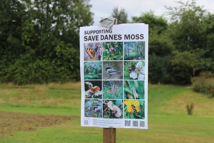 A campaign poster opposing the plans for 950 homes near the Danes Moss Nature Reserve in South Macclesfield. (Image - Alexander Greensmith / Macclesfield Nub News)