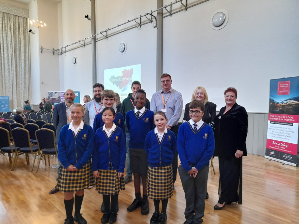 : Pupils from Queens College, Back: (L-R) Jason Loomes - The Field Works, Tim Walker - My Carbon Coach, Ed Prouse – Trees for Good Causes, Nick Golding – SWMAS, Becky Wright – New Leaf Life Design, and Michele Cusack, Acting Lead Director of Economic and Community Infrastructure at Somerset County Council