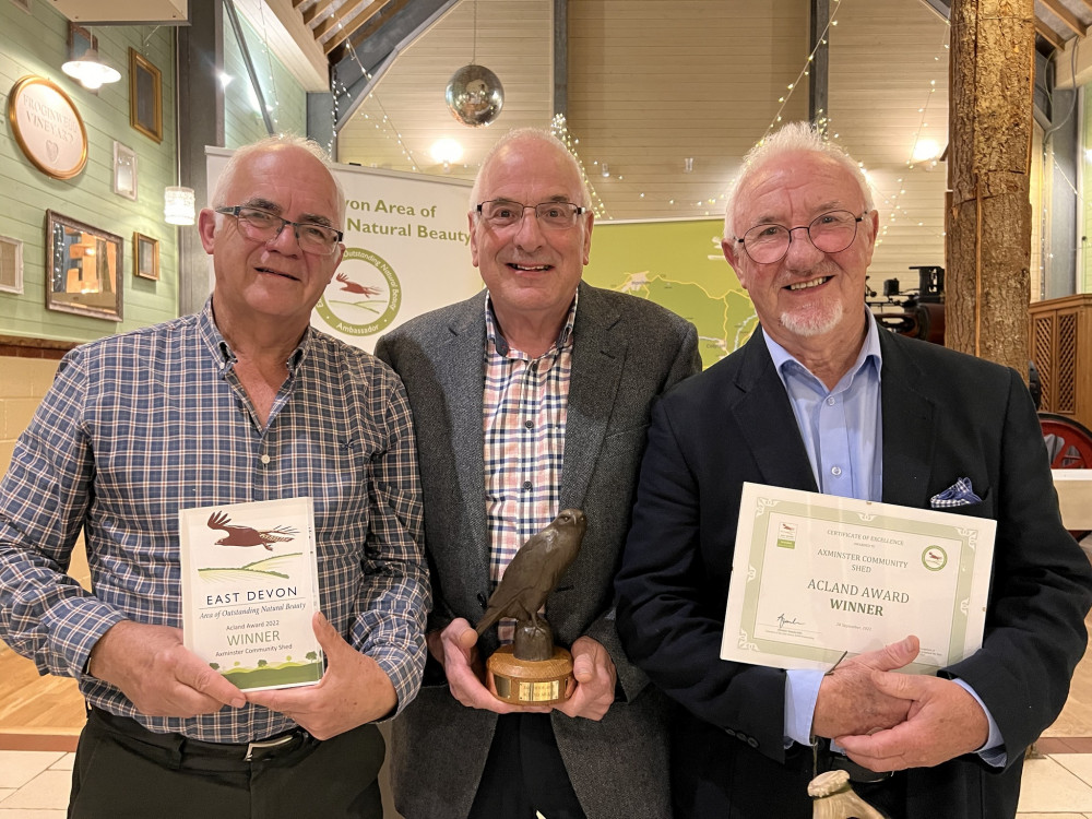 Volunteers from Axminster Community Shed receive their award from the East Devon Area of Outstanding Natural Beauty