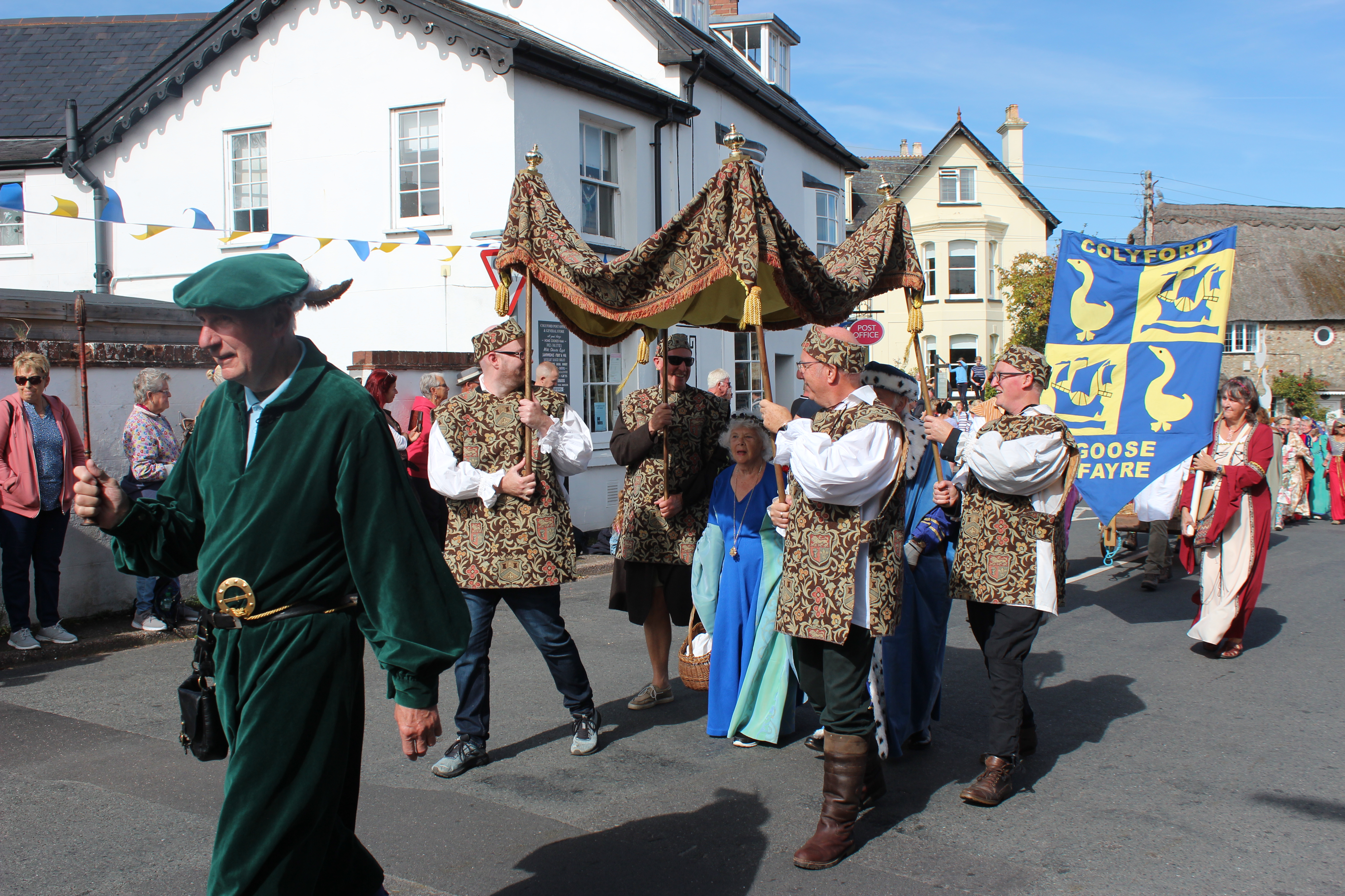 The fayre gets underway with the procession of villagers in costume