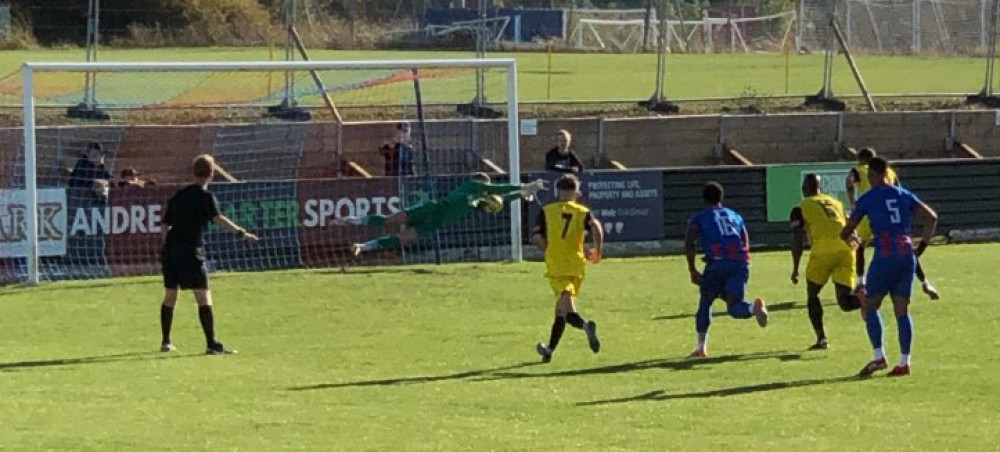 Close, but not close enough. Diving Maldon keeper Tom Middlehurst is just beaten by Alex Hernandez's penalty. 