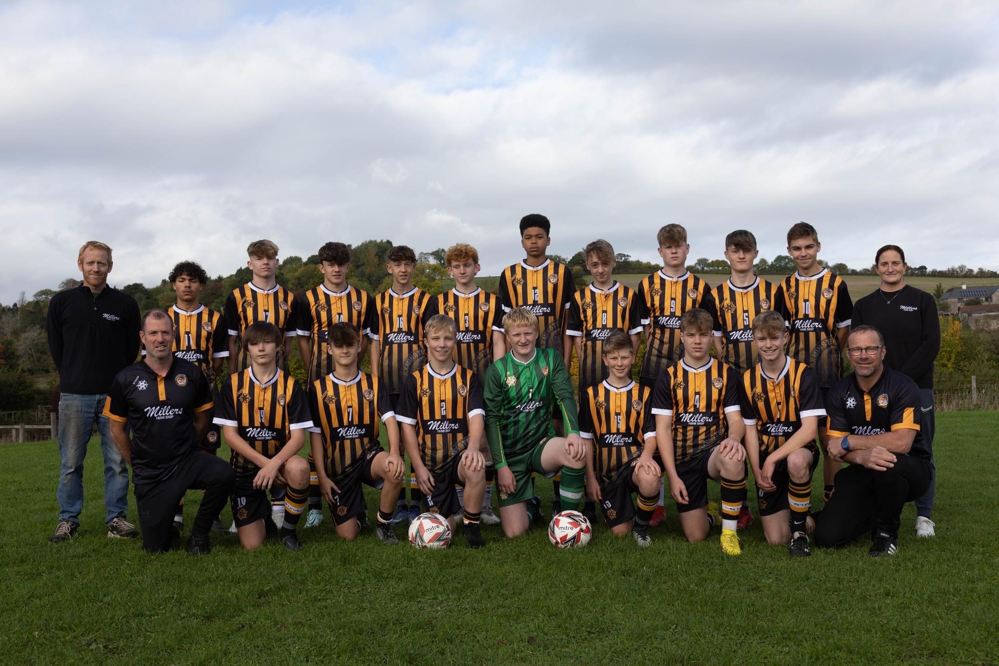 Axminster Town Under 16s have new sponsored shirts, courtesy of Millers Farm Shop. James and Olivia Miller are pictured with the squad at a recent game