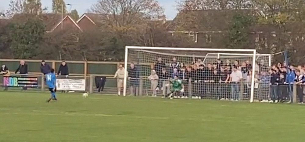 Taylor Banks slots home the penalty to confirm Ramblers' win.