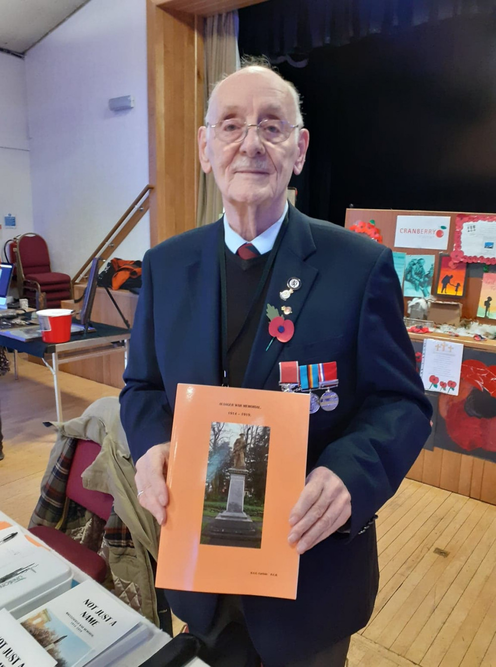 Harry Carlisle with his book about Alsager's war heroes. 