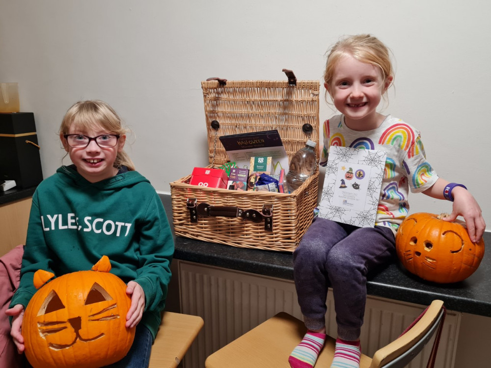 A child poses for photos next to the Pumpkin sculptures by